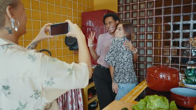 Group of friends bonding at home, LGBTQ and diversity concepts - Homosexual couple and fluid gender non binary young man with cross dressing clothing style having fun in the apartment, LGBT people