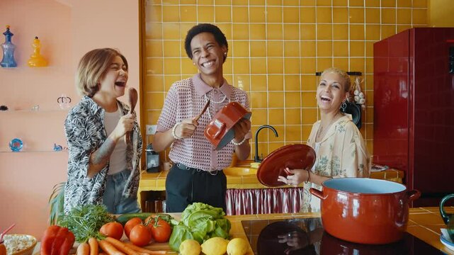 Group of friends bonding at home, LGBTQ and diversity concepts - Homosexual couple and fluid gender non binary young man with cross dressing clothing style having fun in the apartment, LGBT people