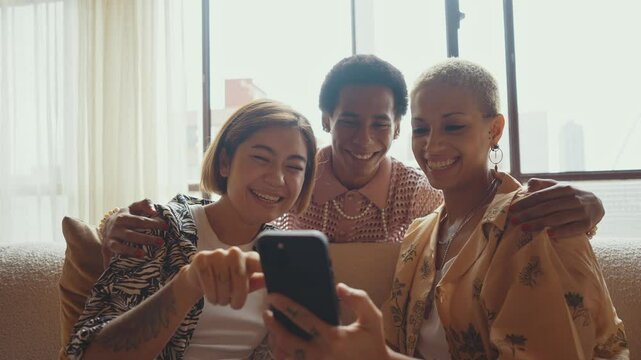 Group of friends bonding at home, LGBTQ and diversity concepts - Homosexual couple and fluid gender non binary young man with cross dressing clothing style having fun in the apartment, LGBT people