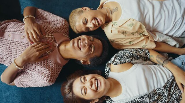 Group of friends bonding at home, LGBTQ and diversity concepts - Homosexual couple and fluid gender non binary young man with cross dressing clothing style having fun in the apartment, LGBT people