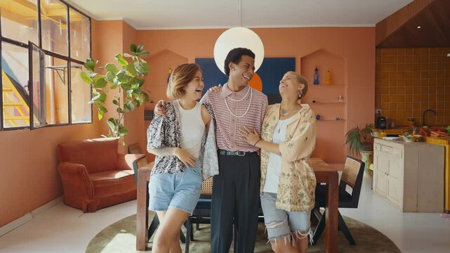 Group of friends bonding at home, LGBTQ and diversity concepts - Homosexual couple and fluid gender non binary young man with cross dressing clothing style having fun in the apartment, LGBT people