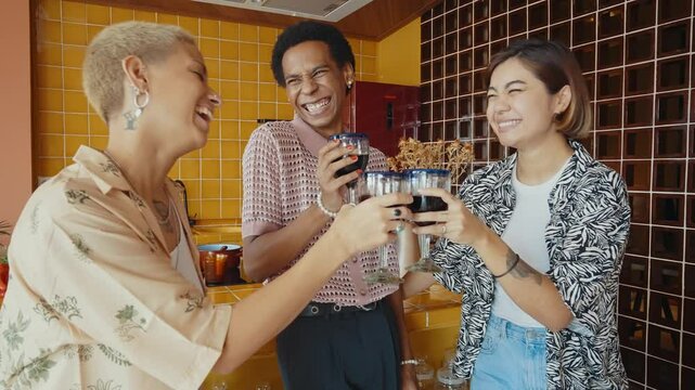 Group of friends bonding at home, LGBTQ and diversity concepts - Homosexual couple and fluid gender non binary young man with cross dressing clothing style having fun in the apartment, LGBT people