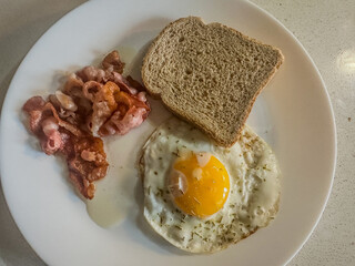 Classic Breakfast with Fried Egg, Bacon, and Toast