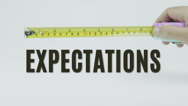 "Expectations" text with a tape measure on a white background, symbolizing precision, accuracy, and measurement in a clean, minimal style