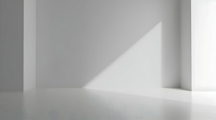 Minimalistic interior with soft light casting shadows on white walls and floor, creating a serene atmosphere