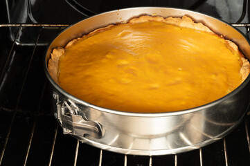 Fresh pumpkin pie baking in the oven. A delicious homemade dessert for Thanksgiving or any time of year. Warm, inviting, and comforting