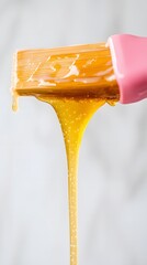 Professional Sugaring Hair Removal Technique - Close-Up of Pink Silicone Brush Applying Sugar Paste on Skin in Beauty Salon