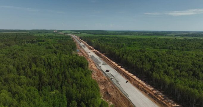 Highway construction. Construction robots preparing road surfaces.Aerial drone view.