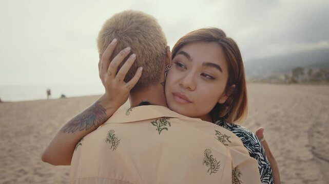 Beautiful multiethnic lesbian couple of lovers dating outdoors - LGBT people bonding and spending time together, concepts about LGBTQ community, diversity, love and lifestyle