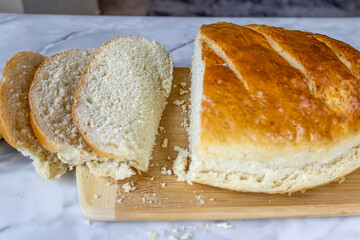 Freshly baked bread on a cutting board.
