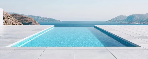 A serene infinity pool overlooks a tranquil sea, framed by distant hills and a clear sky, creating a relaxing oasis.