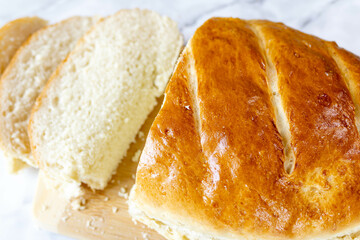 Freshly baked bread on a cutting board.