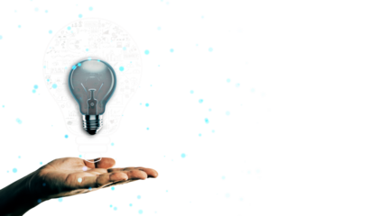 Transparent lightbulb hovering above an open hand with blue glowing particles on a white background, symbolizing creativity and innovation
