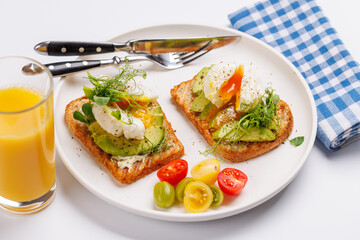Delicious avocado toasts topped with perfectly cooked poached eggs