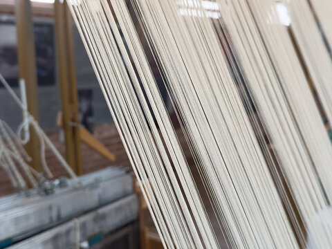 Traditional hand loom,Carpet weaving using traditional techniques on a loom. , close-up of weaving and handmade carpet production.
