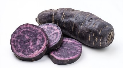 Naklejka premium Purple sweet potato, sliced to reveal its vibrant color, placed on a white surface.