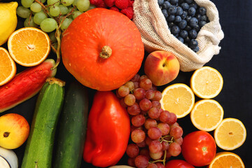 Various healthy fruits, vegetables and cereals on dark background. Top view.
