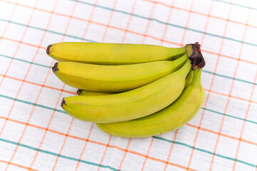 Green banana banana on white elephant with tablecloth