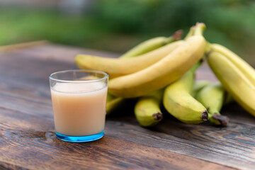The banana juice that it looks delicious against the background of nature