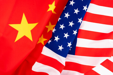 Waving of USA flag and China flag for barrier tariff trade war , economy competition and politic...