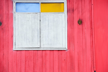 Colorful Window on Pink Wooden Wall in Bright Urban Landscape