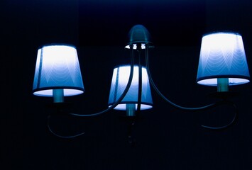 evening dance of light by artificial lighting lamps in the room