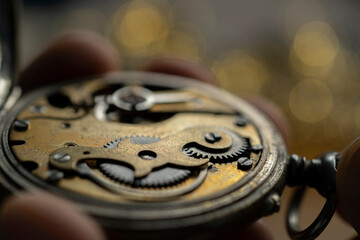 Pocket watch being repaired by senior watch maker, close-up. Black and white.