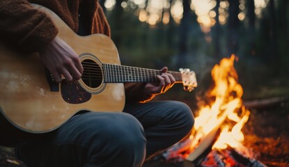 Fototapeta premium Playing guitar by the campfire in a serene forest at dusk
