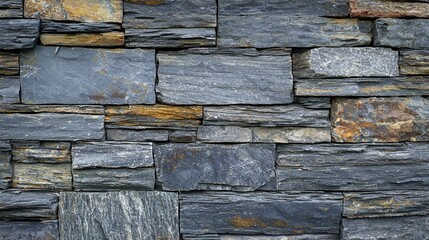 a textured stone wall with various shapes and colors of stones.