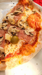 Delicious pizza slice with ham and mushrooms enjoyed during summer vacation in croatia