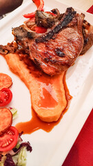Grilled pork chops with sweet potato puree and fresh salad enjoyed during summer vacation in croatia