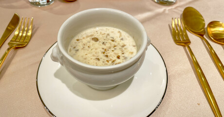 Cream of mushroom soup at a gourmet restaurant with gold silverware