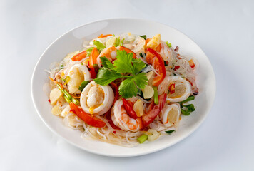 Glass noodle seafood salad on a white background