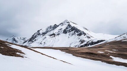 Fototapeta premium Majestic snow capped mountain peak under a cloudy sky in a rugged landscape : Generative AI