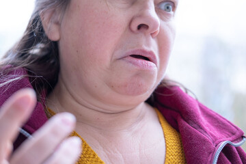Angry mature white woman 50 years old with long hair expressing stress and frustration in natural...