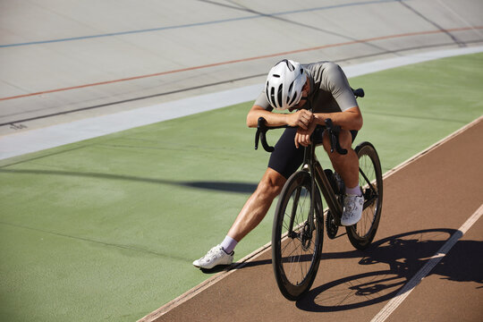 Tired exhausted bicyclist athlete stopped after hard cycling training - Powered by Adobe