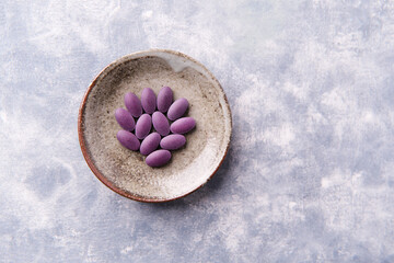 Lutein tablets. Dietary supplement on wooden background. Soft focus. Top view. Close up. Copy space