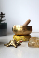 Nepal singing bowl, metal turtle as a sign of wisdom and citrine crystal on the table. 