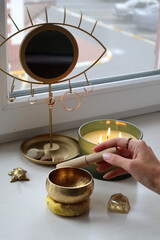 Spiritual Harmony: Meditation & Healing Rituals. Playing Tibetan bowl. Singing bowl and burning candles. Sound vibration healing.