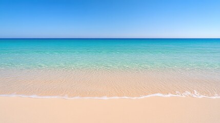 Obraz premium Serene tropical beach with crystal clear water and blue sky