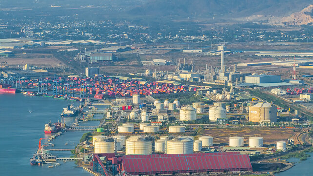 LNG tanker anchored in Gas terminal gas tanks for storage. LPG at Tanker Bay Petroleum Chemical or Methane freighter export import transportation. Cai Mep, Hochiminh city, Vietnam