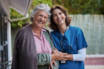 Portrait of senior woman with nurse smiling together