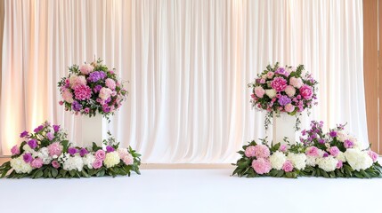 A floral arrangement decorates a stage, featuring elegant pink and white flowers in large vases, set against a soft, flowing backdrop.