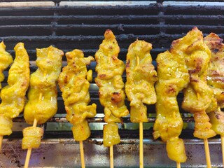 Pork satay, grilled on a stainless steel grill, eaten with toast and peanut sauce, has a sweet and slightly spicy taste. It is a popular grilling menu in Thailand.