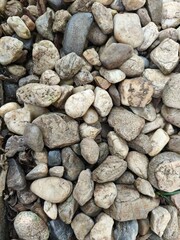 crushed grey stone on ground and texture many sizes and shapes round and square with sharp corners.