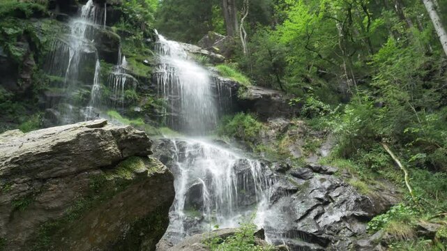 Majestic Zweribach Waterfall in the heart of the Black Forest &ndash; roaring natural wonder with moss-covered rocks, clear water, and an idyllic forest landscape