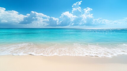 Obraz premium Serene beach with calm waves and clear blue sky on a sunny day