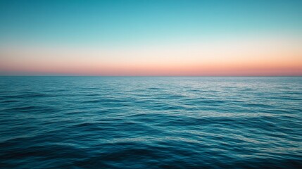 Obraz premium Soft Blue Gradient Sky Transitioning Over Calm Ocean Water