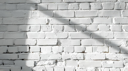 Fototapeta premium White brick wall with subtle texture and shadow play, ideal for backgrounds and designs