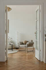 A refined interior setting featuring a boucle lounge chair, warm wood tones, and sculptural decor,...